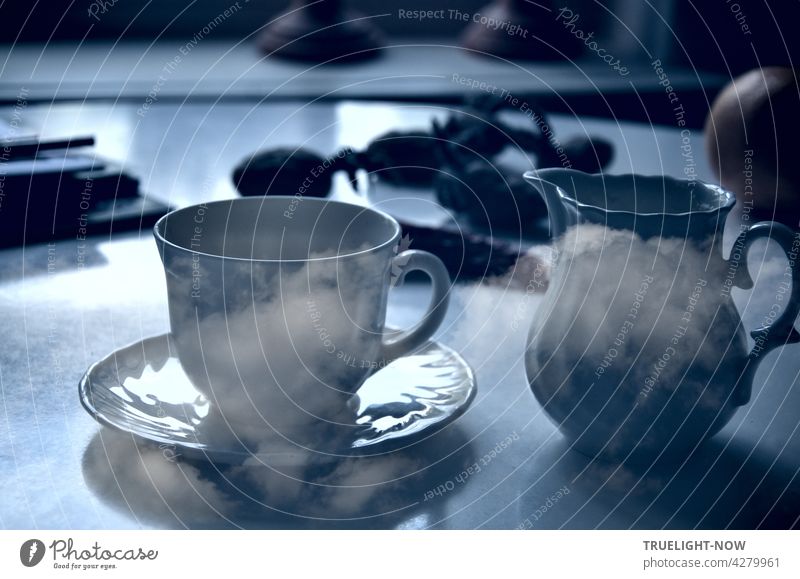 Coffee break with clouds. A round kitchen table stands by the window. Undefinable stuff is lying around on it. But the coffee dishes in the foreground are well recognizable. Confusing only the clouds on it and around it