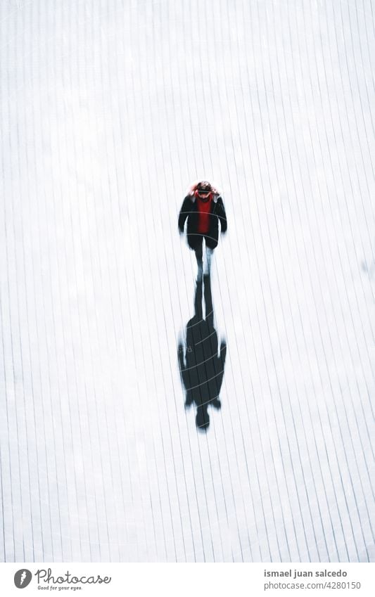 tourist walking around on the street in Bilbao city spain tourism person people human pedestrian shadow silhouette ground outdoors urban city life lifestyle