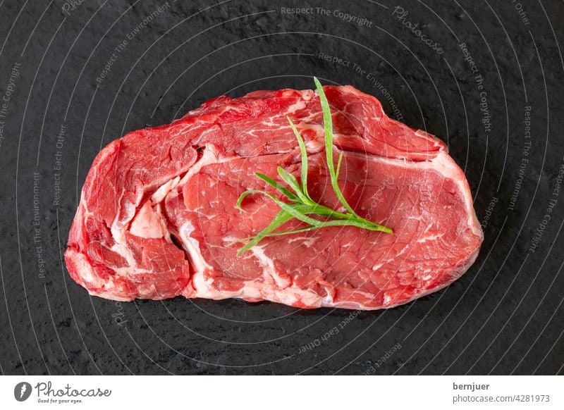 raw steak on black slate Steak uncooked Meat Raw slate plate Protein Sirloin Red Beef Cut background Eating Dinner dry age ingredient White Butcher segregated