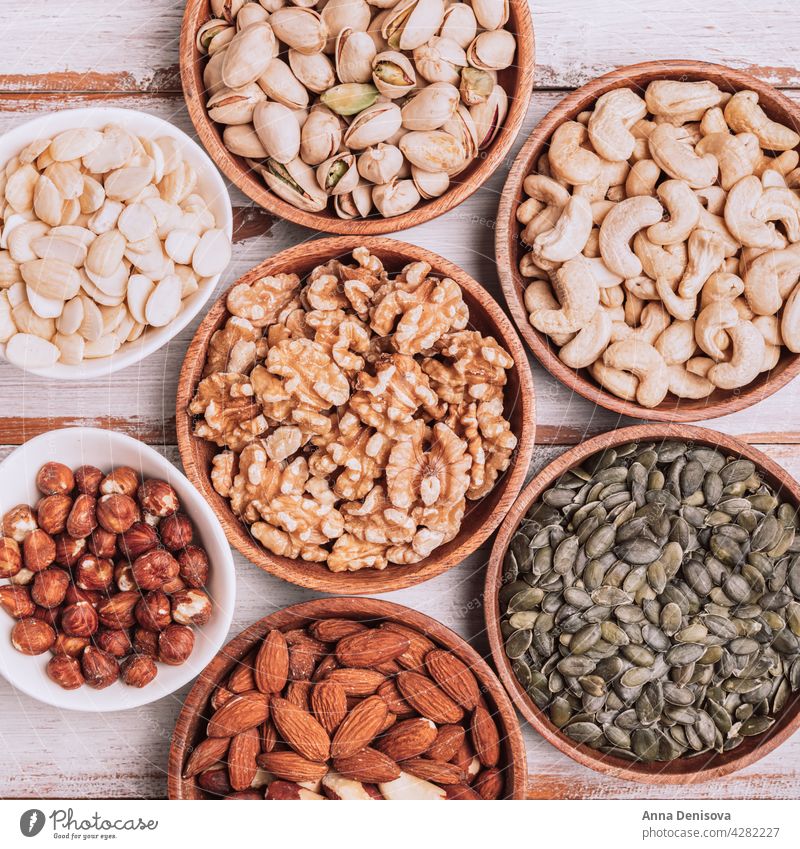 Different kind of nuts in wooden bowls assortment walnut selection snack hazelnut mix healthy seed pistachio pumpkin seeds cashew almond brazilian nut hazelnuts