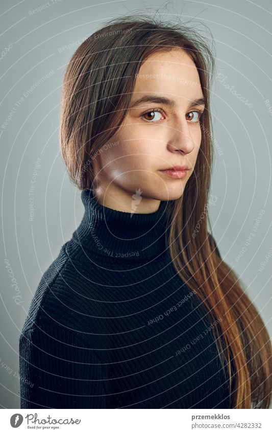 Portrait of young woman. Classic portrait in positive mood, beautiful model posing in studio over plain background headshot person female teenager pretty lady