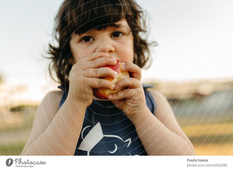 Child eating fresh fruit Girl 3 - 8 years Eating Caucasian Fresh Fruit Nature Natural Authentic Snack Exterior shot Healthy Eating Delicious Nutrition