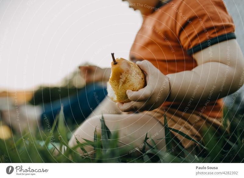 Child eating fresh fruit Snack Pear Fresh Fruit Close-up sweet Healthy Juicy food Delicious Vegetarian diet Colour photo Green Nutrition 1 - 3 years Caucasian