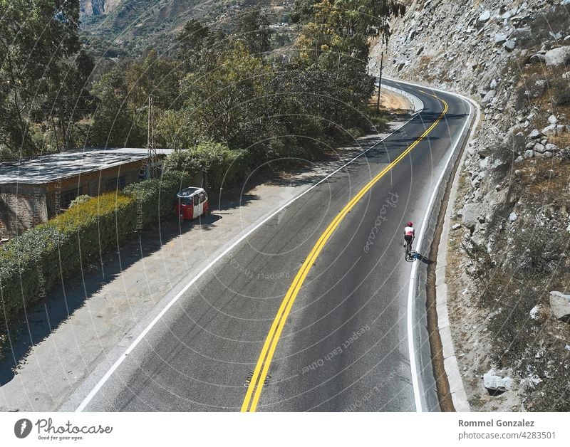 Photo of road cycling. Triathlete train in beautiful nature. Sea and mountains in the background. Matucana, Peru cyclist recreation helmet lifestyle triathlon