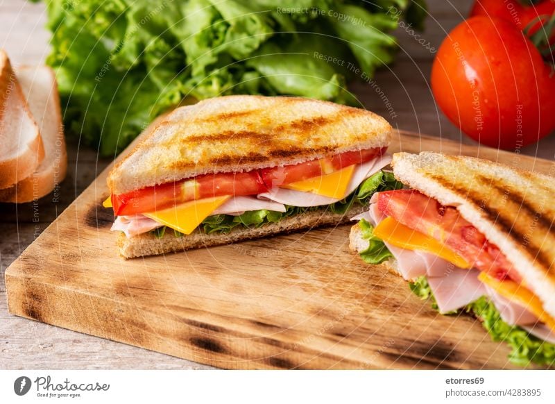 Sandwich with tomato,lettuce,ham and cheese bread breakfast club delicious fast food fresh grilled ingredient panini pressed sandwich smoked snack triangle