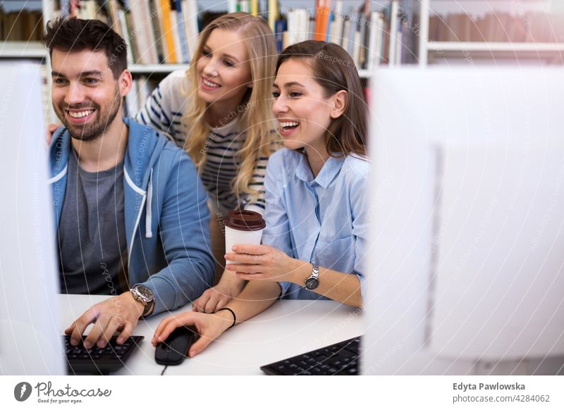 College students in a library enjoying lifestyle young adult people casual caucasian positive happy smiling woman female attractive beautiful bookstore reading