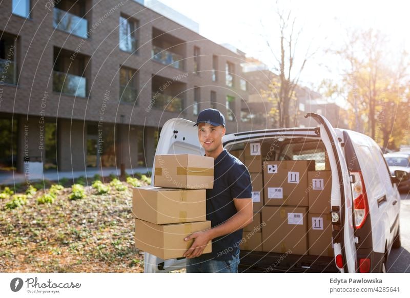 Delivery man with his van delivery van car driver truck people young adult male smiling happy blue collar Courier dispatch rider delivery man delivering package