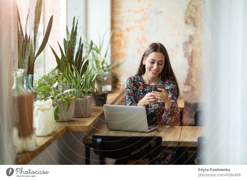 Woman with laptop in cafe people woman young adult casual attractive female smiling happy Caucasian toothy enjoying one person beautiful portrait positivity