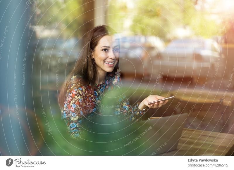 Woman with laptop in cafe people woman young adult casual attractive female smiling happy Caucasian toothy enjoying one person beautiful portrait positivity