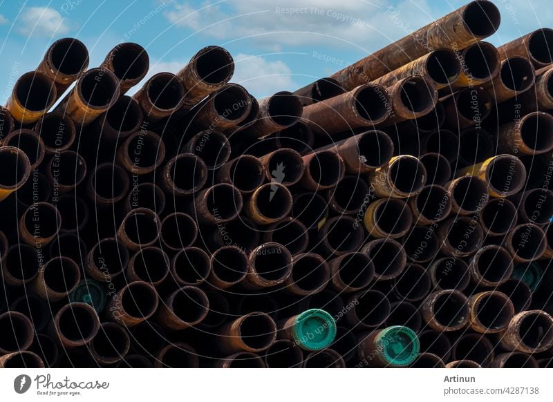 Pile of old rusty round metal industrial pipe. Steel pipe stack at warehouse of factory. Industrial material. Metal corrosion. Stack of rusty tube. Old iron pipe at warehouse. Metal pipe industry.