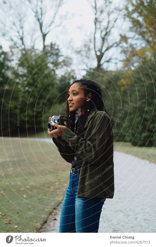 Young Girl With Camera Feminine Young woman Youth (Young adults) 18 - 30 years Adults Leisure and hobbies Take a photo Photographer Ease Black Photography