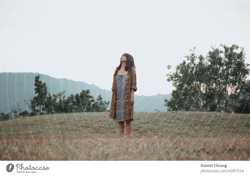 Girl Enjoy The Moment In The Empty Grass Land Forest one alone girl young teen woman female lifestyle leisure outdoors teenager beautiful mood moody standing