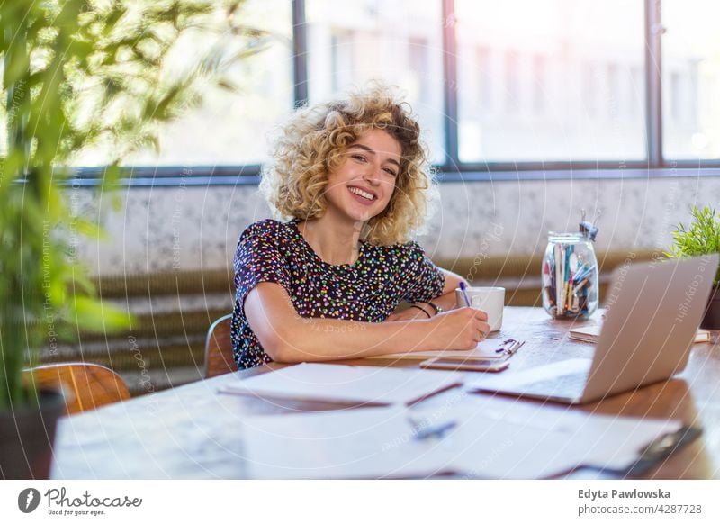 Portrait of confident creative woman in her office business businesspeople businessperson businesswoman caucasian female indoors informal casual young adult