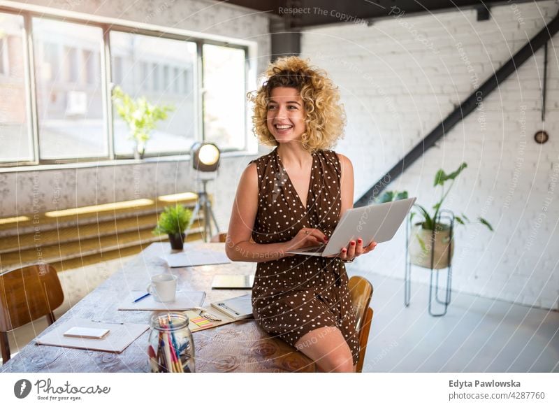 Portrait of confident creative woman in her office business businesspeople businessperson businesswoman caucasian female indoors informal casual young adult