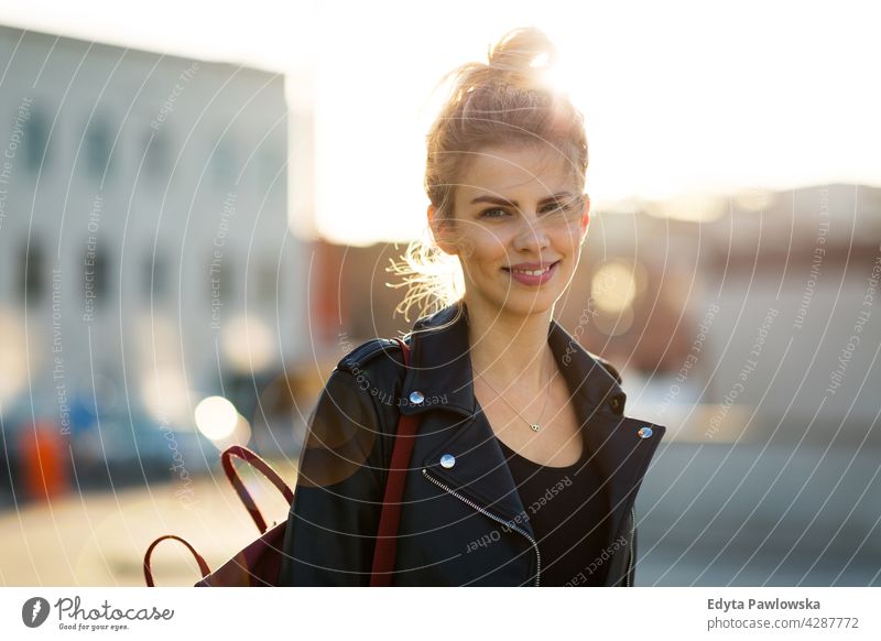 Young woman in the city at sunset enjoying lifestyle young adult people casual caucasian positive happy smiling female attractive beautiful day outdoors urban