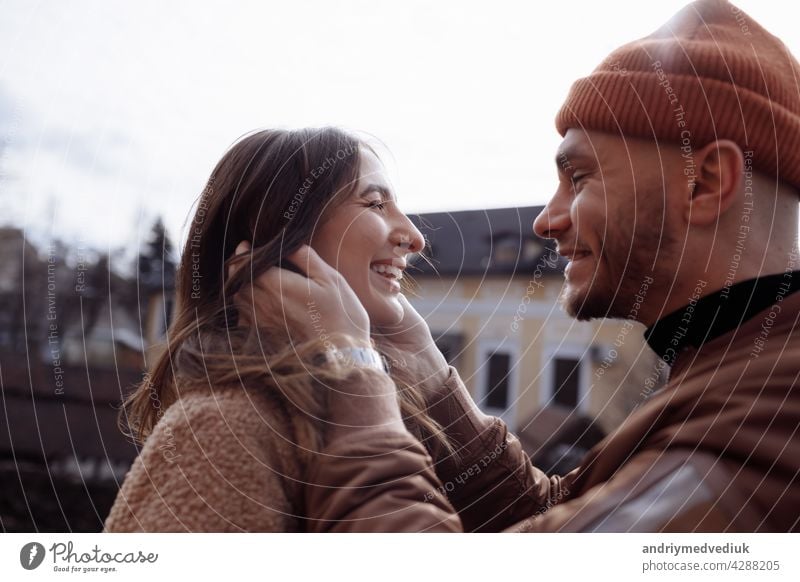 in love stylish young couple kissing in the city. Fashion outdoor sensual romantic portrait of beautiful young couple hugs and kissing on the city. selective focus