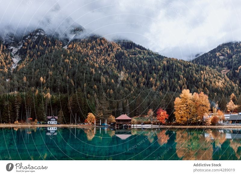 Reflection of mountain and trees on lake in dolomite forest water tourism landscape beautiful village colorful travel nature panorama park dobbiaco trentino