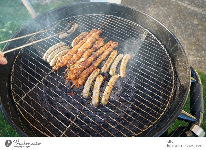 Grilling with sausages and meat skewers with smoke over hot embers BBQ Meat Bratwurst Barbecue (apparatus) BBQ season Hot Steak barbecue grilled Smoke