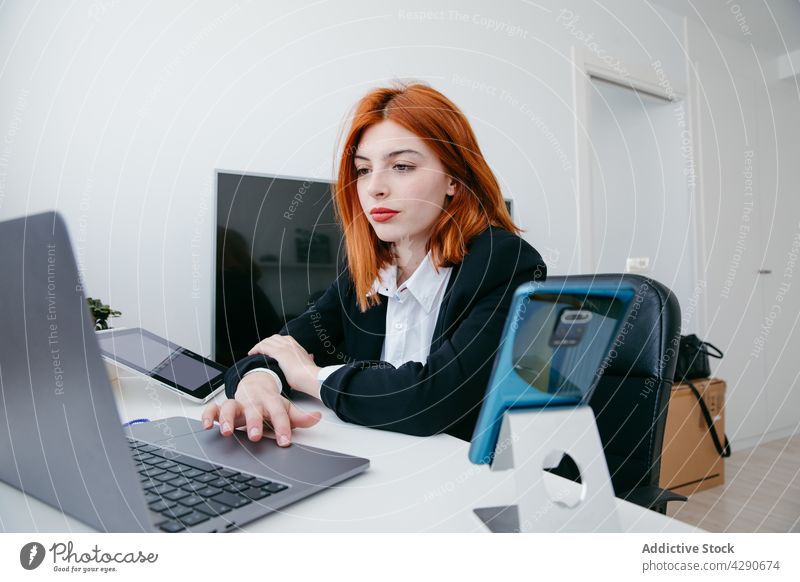 Businesswoman typing on laptop at table in house businesswoman startup project black screen work independent home using gadget device smartphone netbook