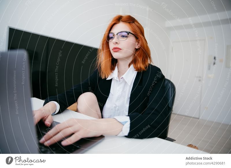 Businesswoman typing on laptop at table in house businesswoman startup project black screen work independent home using gadget device smartphone netbook