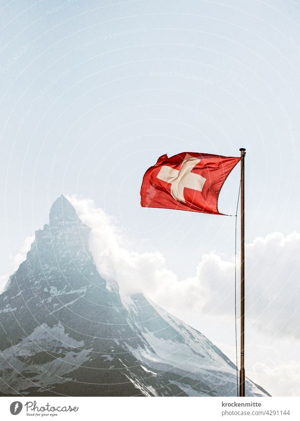 Swiss flag in the wind in front of Matterhorn Switzerland Flagpole Ensign Patriotism Blow Wind Sky Judder Pride Clouds Blue Exterior shot Red Zermatt Landmark