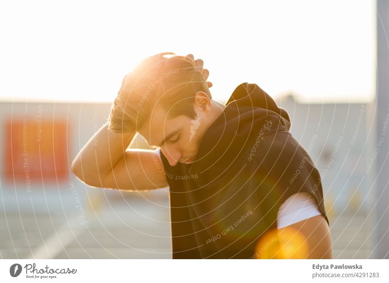 Young man at sunset in urban area Jogger runner jogging running people young male energy exercise clothing exercising fitness recreation sport healthy lifestyle