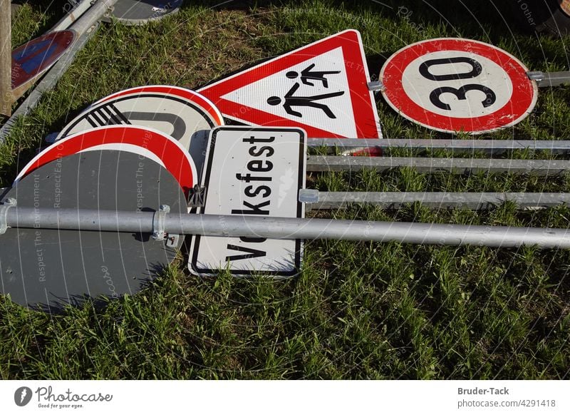 Traffic signs lying on the ground Verlehrszeichen folk festival zone 30 Signs and labeling Signage Characters Warning sign Transport Road sign Lanes & trails