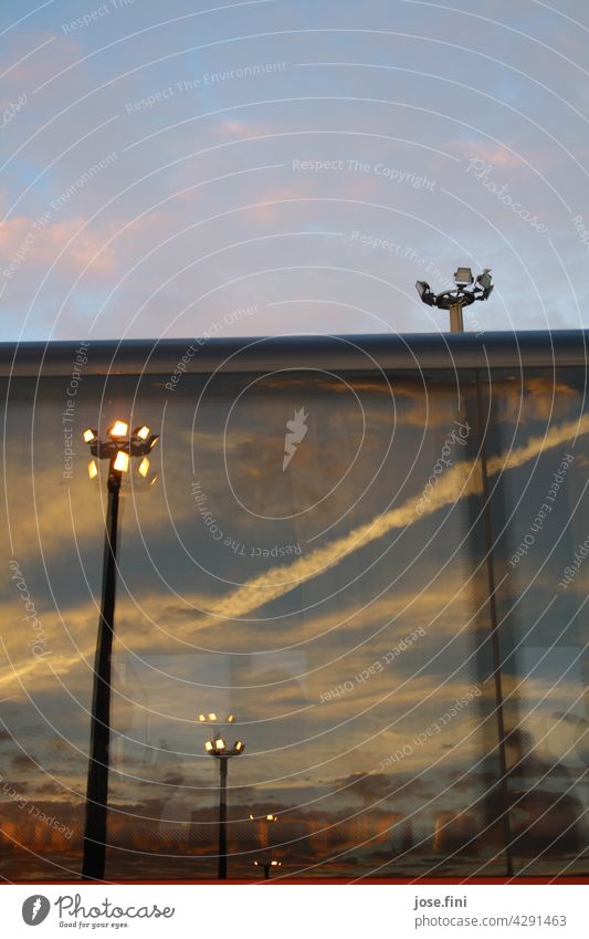 Reflection of large concrete piles Spotlight, floodlight in evening sky Concrete stake Floodlight Light Illuminate Sky Twilight Evening Airplane Ferry ship