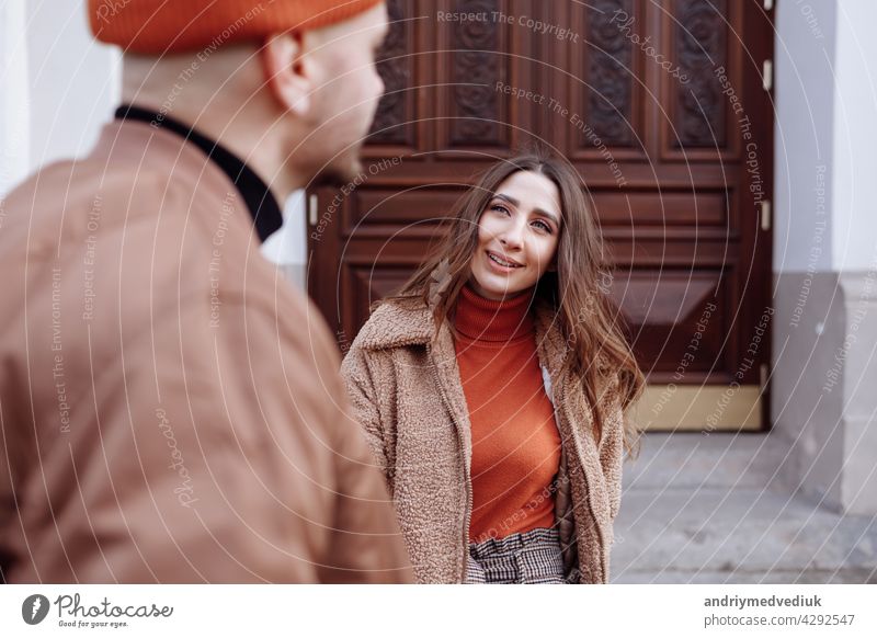 Beautiful Tourist Couple In Love Walking On Street Together. Happy Young Man And Smiling Woman Walking Around Old Town Streets, Looking At Architecture. Travel Concept