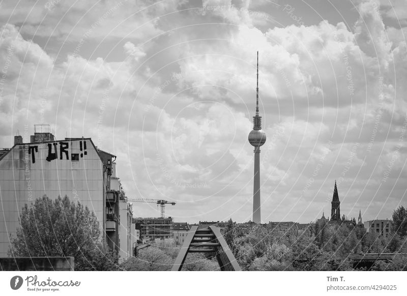 View towards Prenzlauer Berg with television tower Schwedt Footbridge Television tower b/w Zion Church wall park Graffiti Bridge Sky Crane Black & white photo