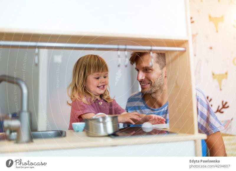 Father Playing with Daughter At Home home house man dad father family parent relatives child daughter girl little girl kid kids children relationship together