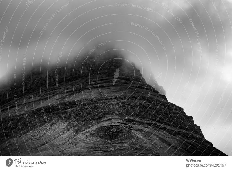 The top of the mountain is shrouded by a cloud, its eye looks at you Steep slope Eyes Weather Fog Sky Peak Above height Rock Mountain Clouds Landscape Nature