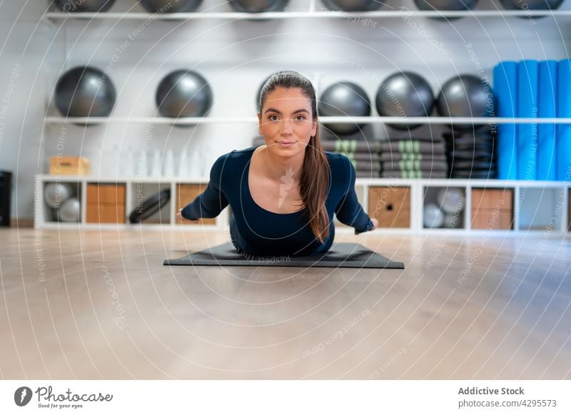 Flexible woman stretching body in yoga pose locust salabhasana prone backbend stress relief position mindfulness balance practice female zen wellbeing wellness