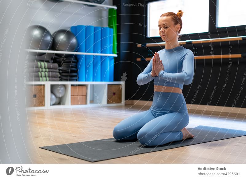 Tranquil woman meditating in yoga pose meditate hero virasana namaste mindfulness stress relief balance position practice female zen wellbeing wellness