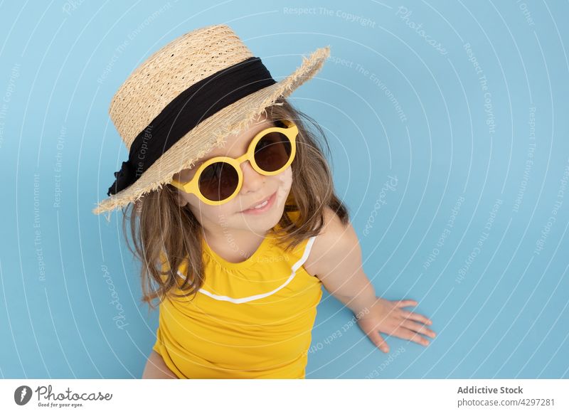 Stylish little girl in summer outfit style yellow fashion happy smile kid sunglasses beach child cute bright cheerful trendy carefree straw hat color cool