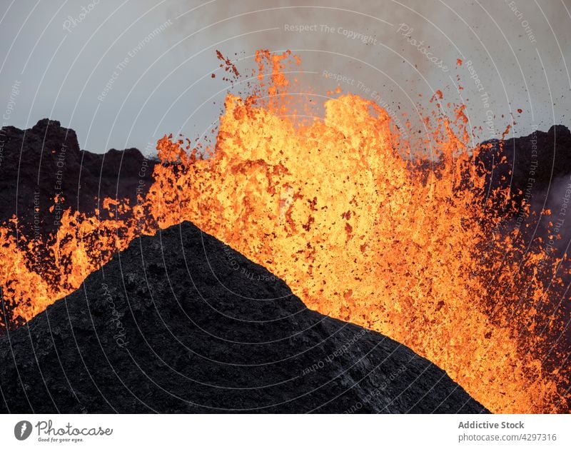 Volcano bursting with hot lava volcano mountain nature geology smoke catastrophe energy iceland volcanic peak burn molten rock heat fume steam formation rough