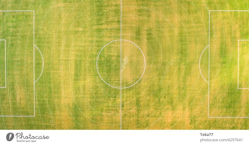 a small football field from above panorama sports football field top down green grass sun lines football field in summer