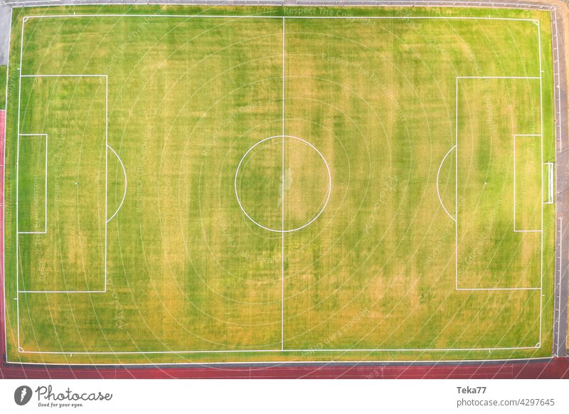 a small football field from above sports football field top down green grass sun lines football field in summer