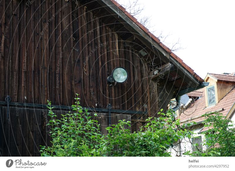 Wooden barn with brown wooden boards and spotlights on the facade Barn Floodlight Facade Building Wall (building) House (Residential Structure)