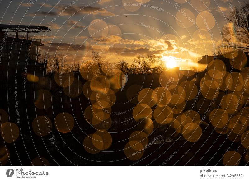 Berlin sunset Sunset Window Window pane Rain raindrops Slice Glass Pane Water Drops of water bokeh Lens flare Sunbeam rays Night Evening Vantage point sight