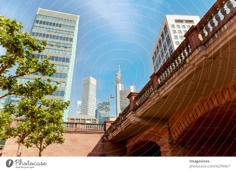 Skyline Frankfurt - View from under the bridge - Untermainbrücke at the blue clear cloudy sky. Skyscrapers in Frankfurt - Main in Germany, Hesse view from below