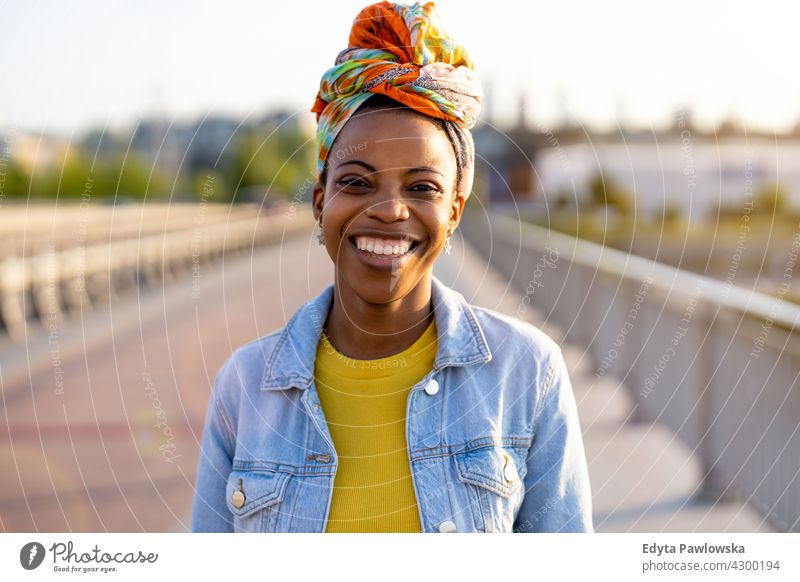 Portrait of smiling young woman in the city afro proud real people city life African american afro american student Black ethnicity sunny sunset outside pretty