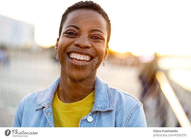 Portrait of a beautiful happy woman outdoors afro proud real people city life African american afro american student Black ethnicity sunny sunset outside pretty