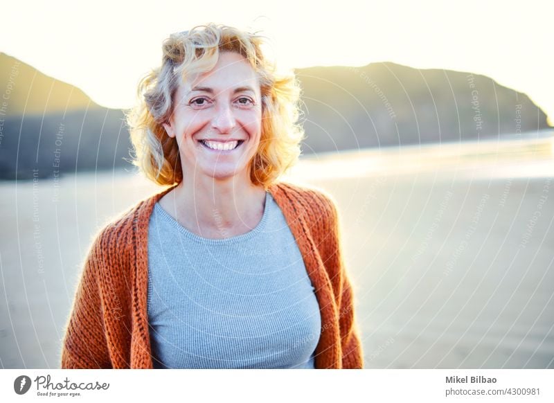 Young mature blonde caucasian woman outdoor in a beach in a sunny day. Lifestyle concept. lifestyle portrait wellness women healthy relaxation lifestyles joyful