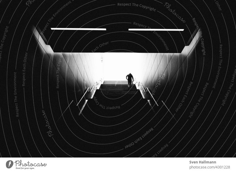 man climbs a staircase Stairs Staircase (Hallway) black-and-white Descent step Dark stair treads stagger Legs Old town Metal metal grid Metal railings Diagonal
