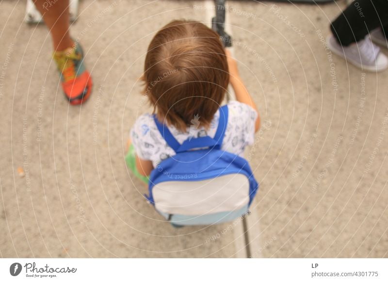 silhouette of a child wearing a backpack sitting down on the floor outdoor recreation Structures and shapes Education Playing contrast Lifestyle Harmonious