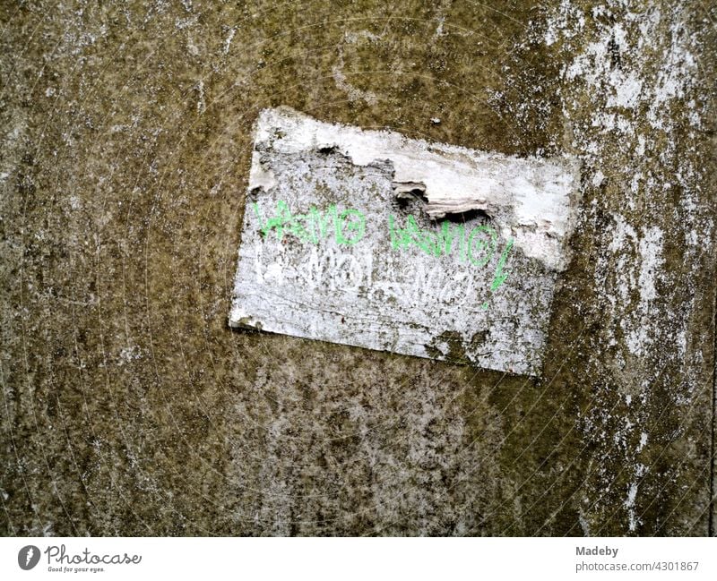 Yellowed and softened old paper sticker on a distribution box with patina in Oerlinghausen near Bielefeld in the Teutoburg Forest in East Westphalia-Lippe