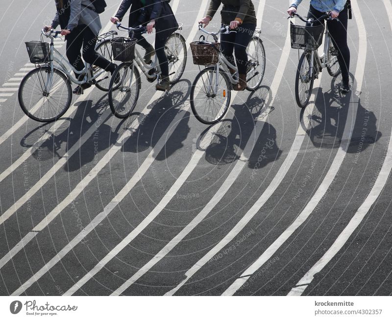 Four female cyclists cross the Superkilen facility in Copenhagen structure Structures and shapes asphalting Progress Lined Landmark on track streamline shape