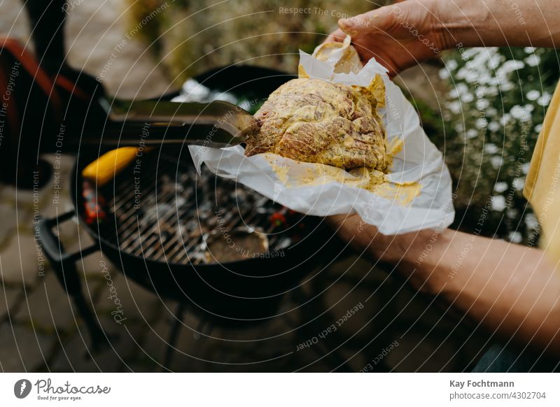 hands picking up raw steak with barbecue tongs backyard bell pepper cooking cookout corn corn on the cob day delicious food food and drink grill grilling