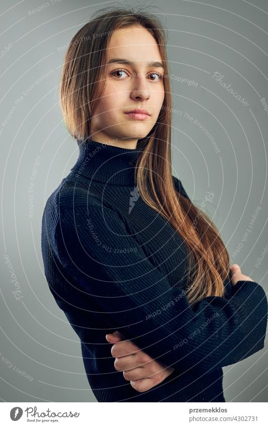 Portrait of young woman. Classic portrait in positive mood, beautiful model posing in studio over plain background headshot person female teenager pretty lady